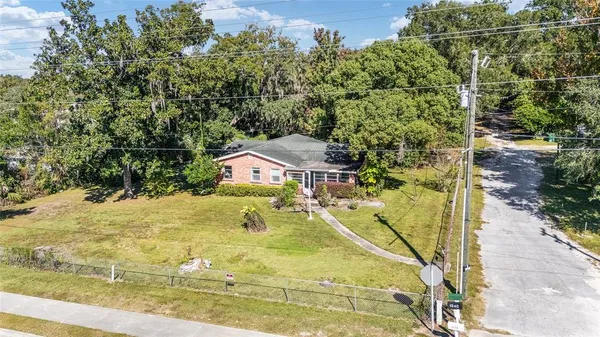 a view of a house with pool and sitting area