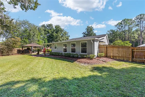 a view of swimming pool with a yard and trees
