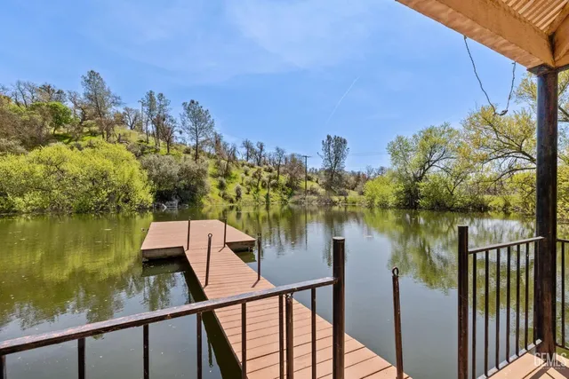 a view of a dinning table and chairs in patio of the house