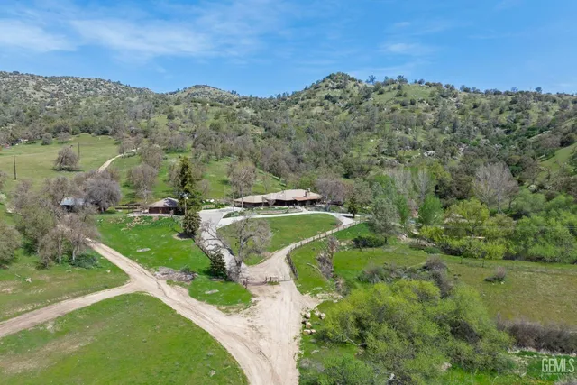 a view of a swimming pool with a patio and a yard