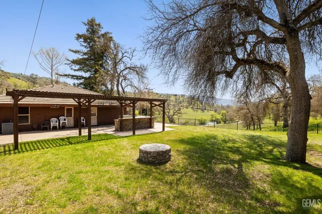 a living room with furniture and a view of the kitchen