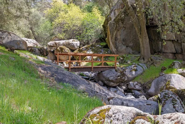 a kitchen with granite countertop sink and refrigerator