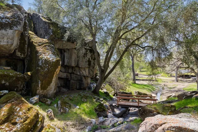 a dining hall with stainless steel appliances granite countertop a sink and wooden cabinets