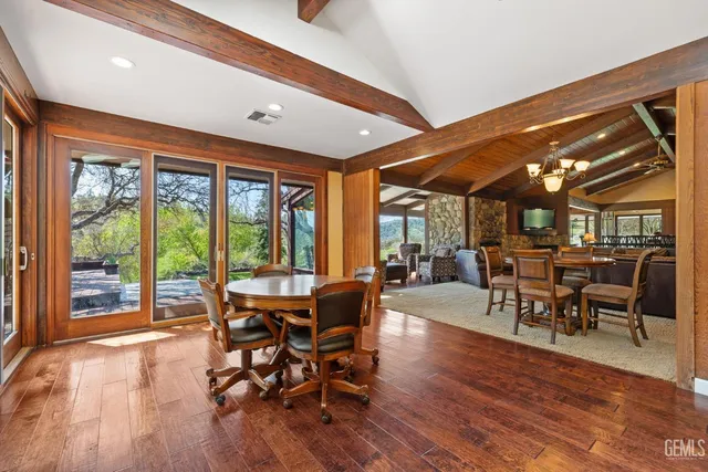 a living room with furniture kitchen view and a window
