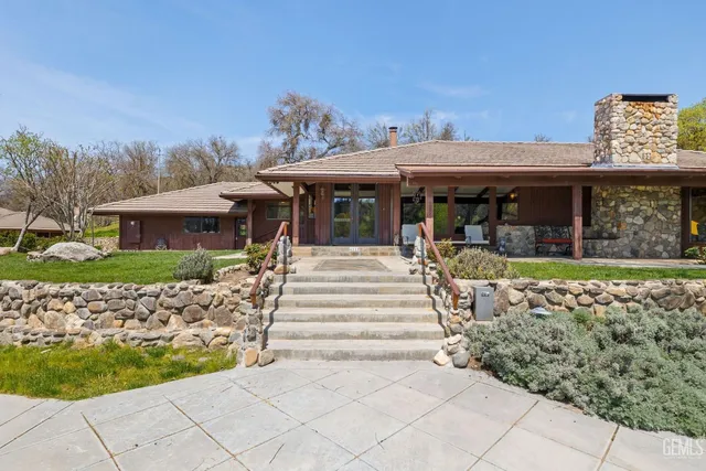 an aerial view of green landscape with trees houses and mountain view