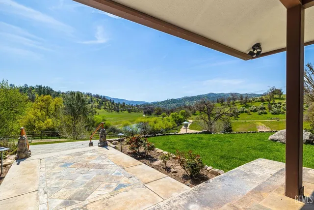 a view of a lush green hillside and a houses