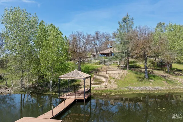 a view of a house with backyard sitting area and garden