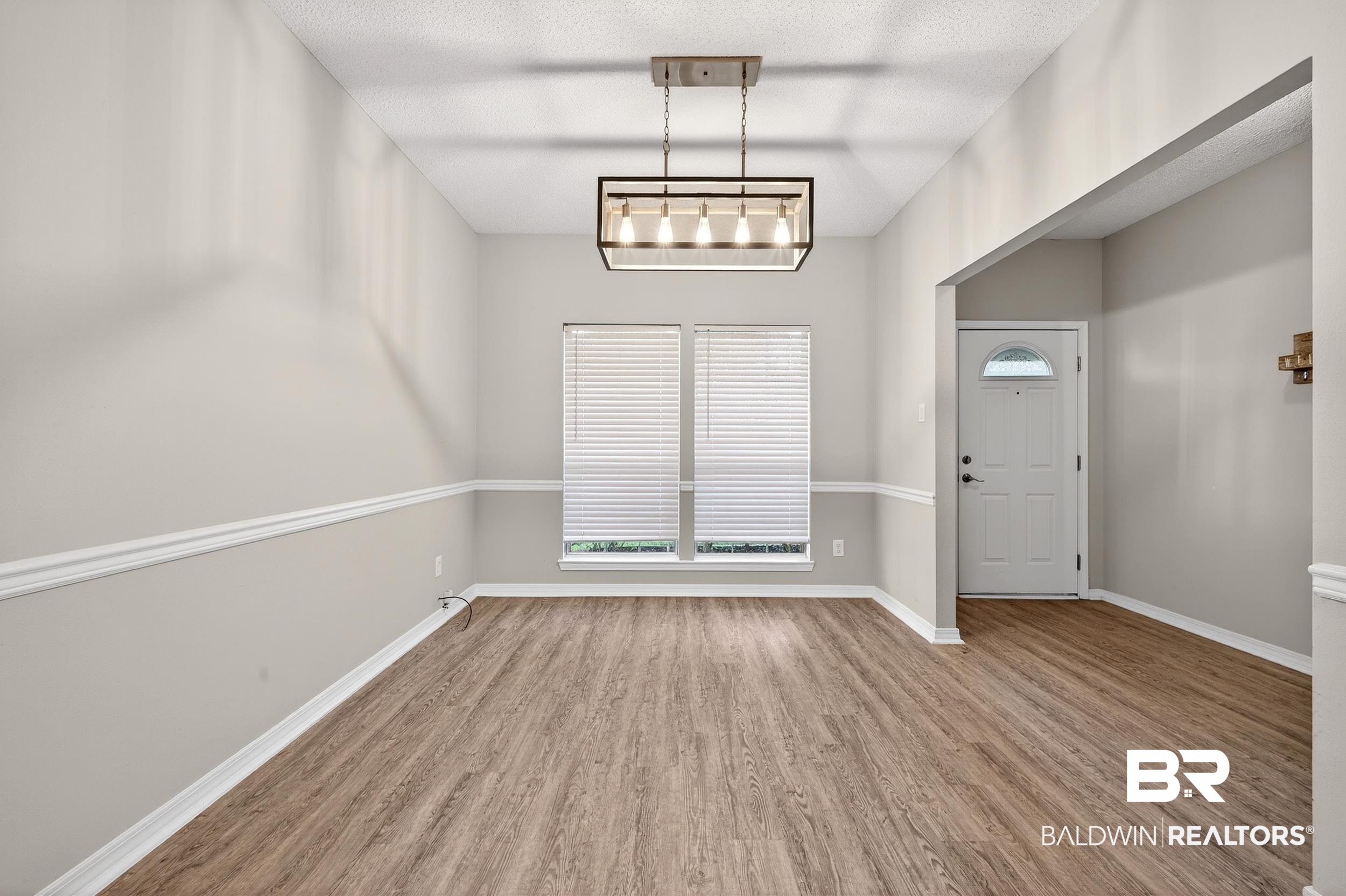7050 Highpointe Place West Daphne, AL 36527 - Photo 14 of 66 Unfurnished dining area with light wood finished floors, a textured ceiling, and plenty of natural light
