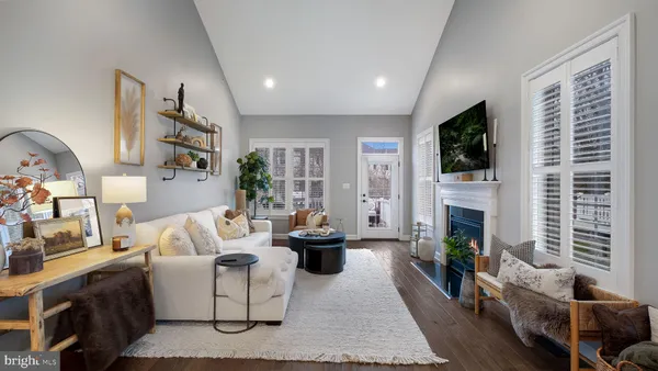 a living room with fireplace furniture and a flat screen tv