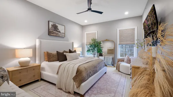 a bedroom with a bed couch and window