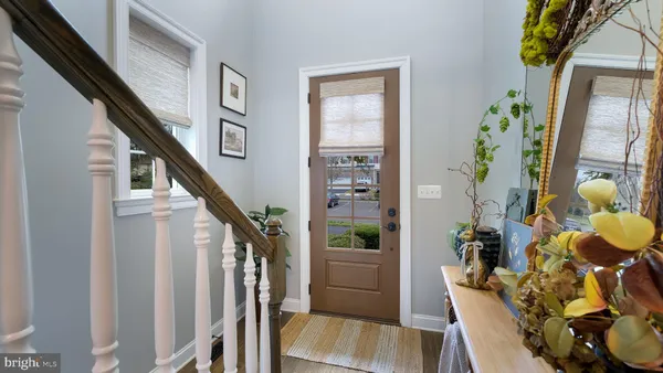a view of an entryway with wooden floor and windows