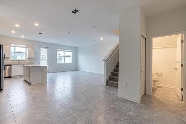 a view of a big room with closet and windows
