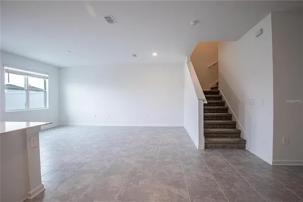 a view of an empty room with stairs