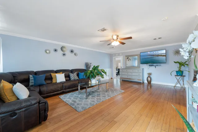 a living room with furniture and wooden floor