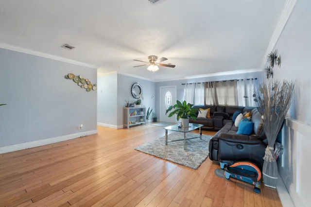 a living room with furniture and a wooden floor