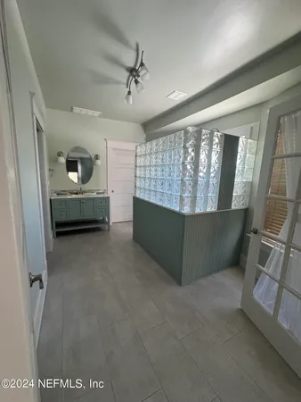 a view of an empty room with a fireplace and a window