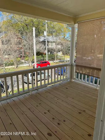 a view of a balcony with wooden floor