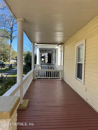 a view of a room with wooden floor and windows