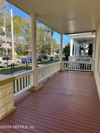 a view of a porch with wooden floor