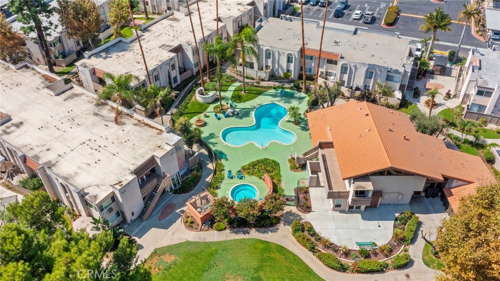 an aerial view of a house with a swimming pool and outdoor seating