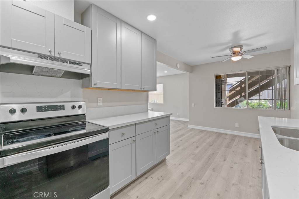 212 South Kraemer Boulevard, Unit 709 Placentia, CA 92870 - Photo 11 of 32 a kitchen with a stove and white cabinets