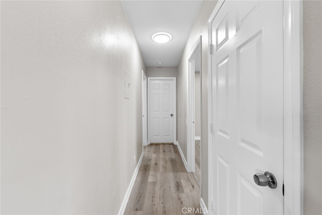 212 South Kraemer Boulevard, Unit 709 Placentia, CA 92870 - Photo 14 of 32 a view of a hallway with wooden floor and a mirror