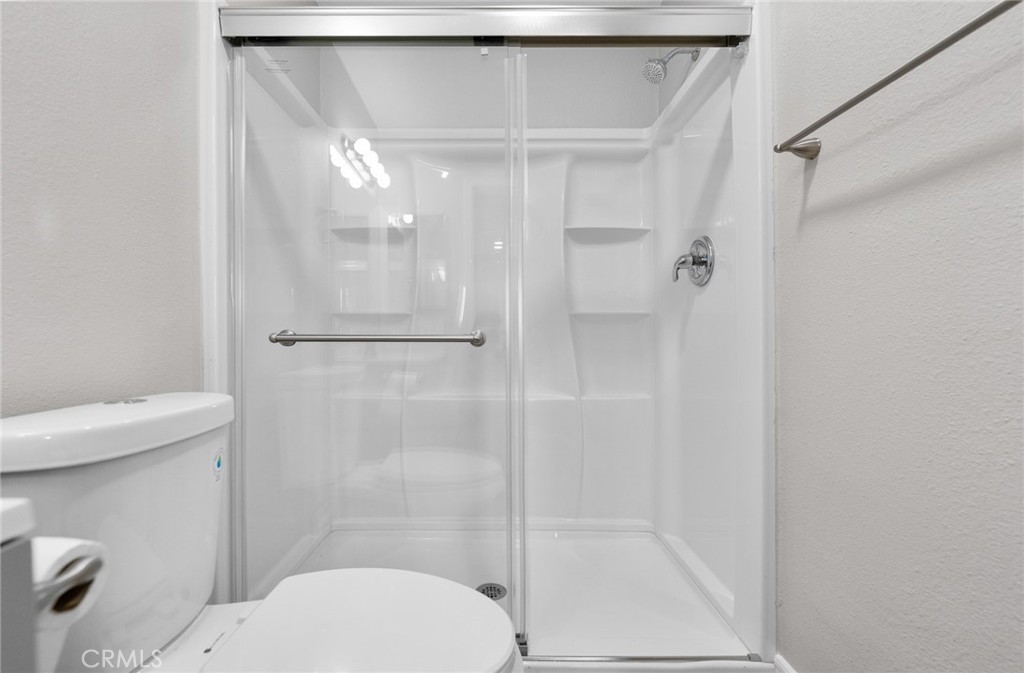 212 South Kraemer Boulevard, Unit 709 Placentia, CA 92870 - Photo 25 of 32 a bathroom with a shower and a toilet