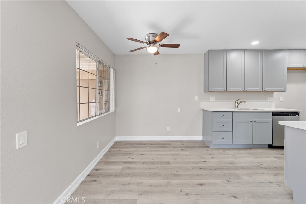 212 South Kraemer Boulevard, Unit 709 Placentia, CA 92870 - Photo 8 of 32 a view of a kitchen with wooden cabinet and a ceiling fan a ceiling fan
