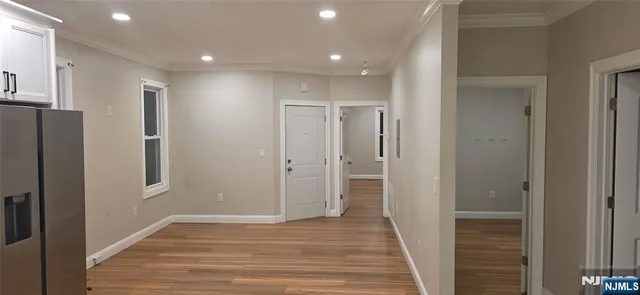 a view of hallway with wooden floor