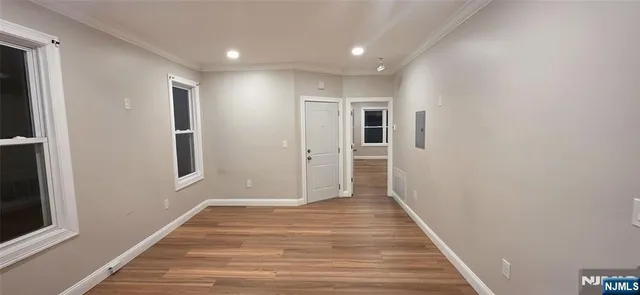 a view of hallway with wooden floor