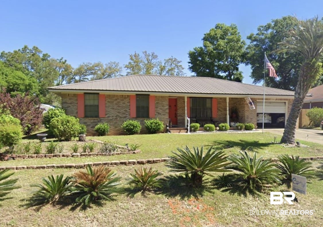 2861 Avenida Alberto Lillian, AL 36549 - Photo 1 of 1 Ranch-style home featuring a garage, a front lawn, driveway, covered porch, and brick siding