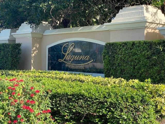 1610 North 42ND Circle, Unit 207 Vero Beach, FL 32967 - Photo 1 of 24 a sign that is sitting in front of flowers