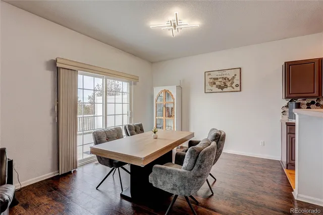 a view of a dining room with furniture window and wooden floor