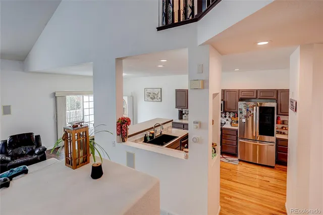 a kitchen with stainless steel appliances kitchen island granite countertop a sink and refrigerator