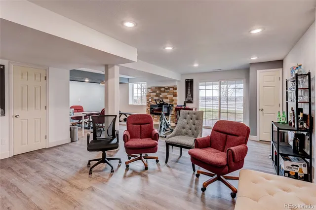 a living room with furniture a rug and a bookshelf