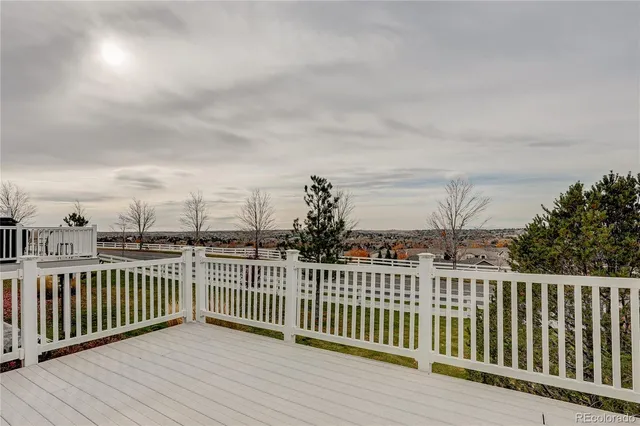 a view of a balcony with wooden fence