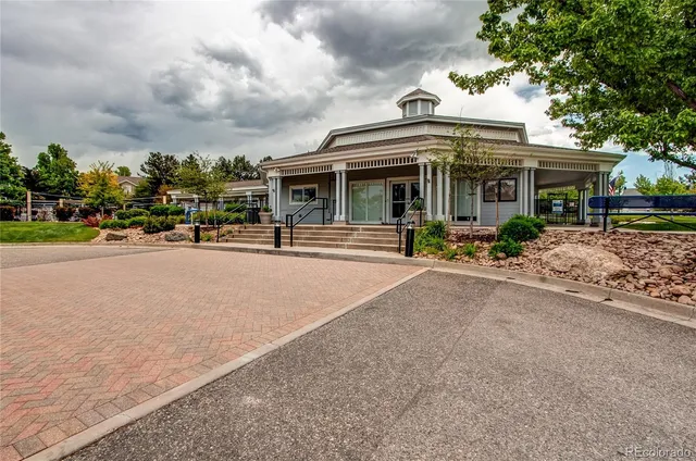 a view of a building with cars parked on road