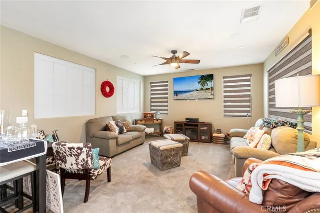 a bedroom with furniture and a large window