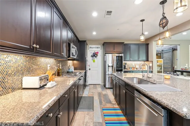 a kitchen with stainless steel appliances granite countertop lots of counter top space