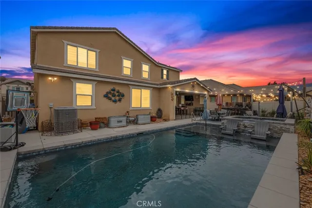 a view of a house with swimming pool and sitting area
