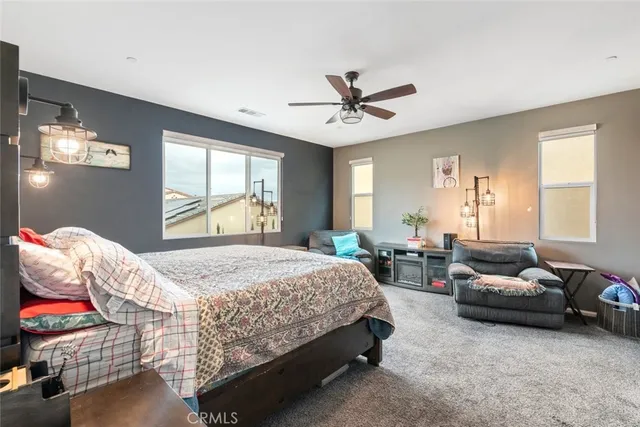 a bedroom with a bed couch and window