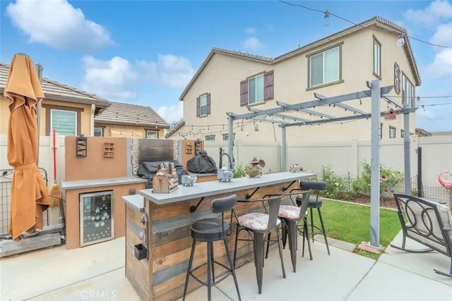 a view of a patio with table and chairs and potted plants