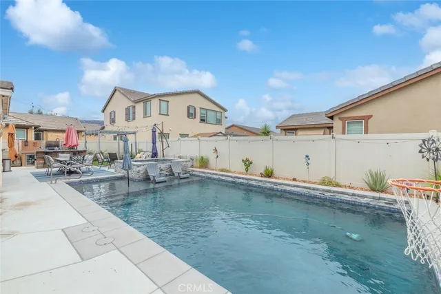 a swimming pool view with a outdoor seating