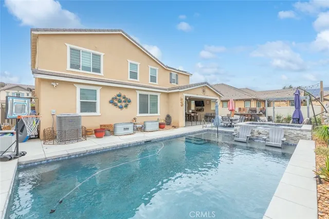 a house view with swimming pool and sitting space