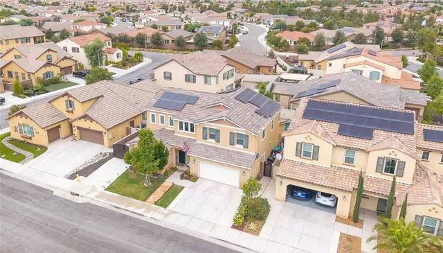 an aerial view of residential houses with street