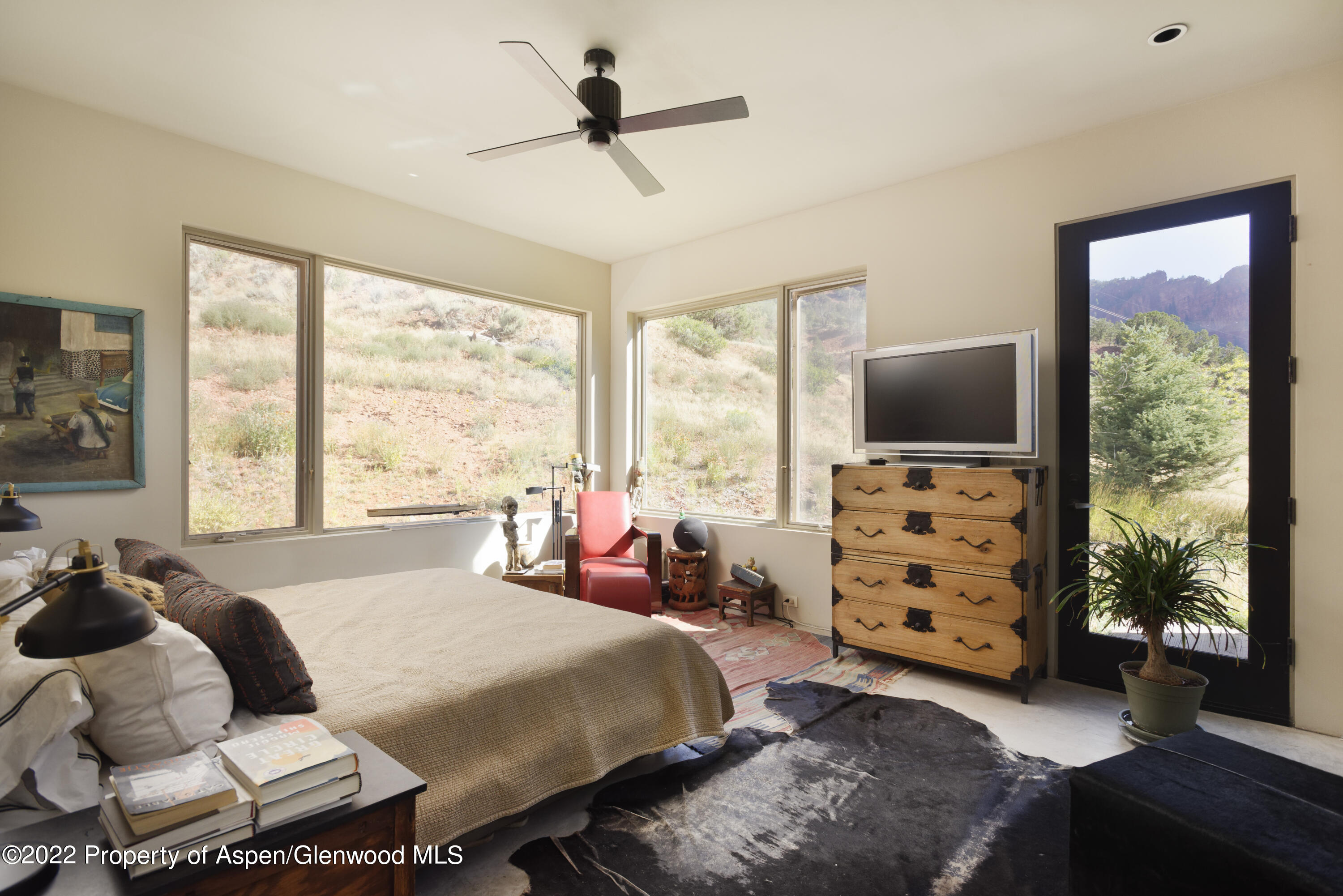202 Castle View Drive Basalt, CO 81621 - Photo 11 of 29 a bedroom with a bed a couch and a flat tv screen