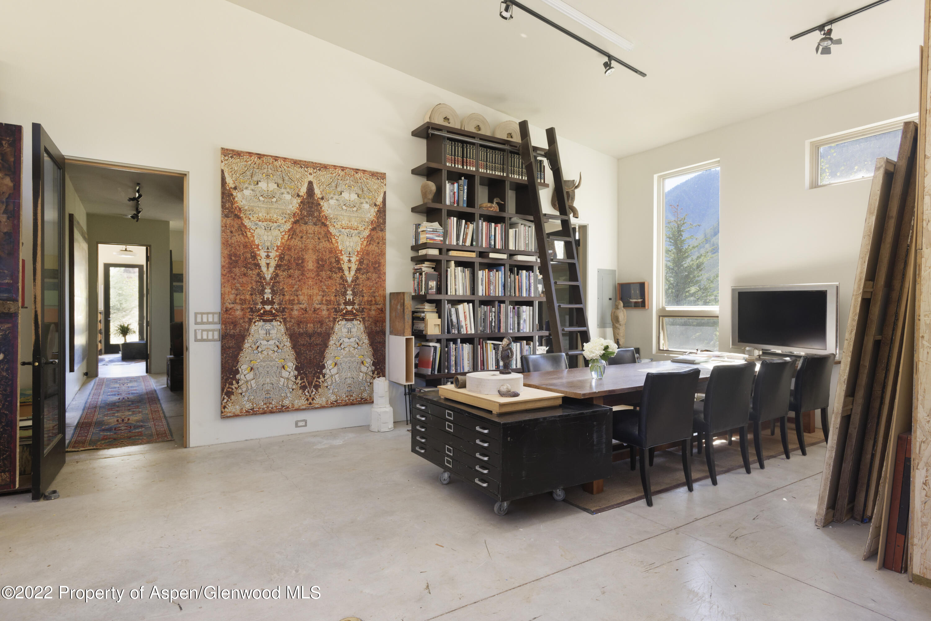 202 Castle View Drive Basalt, CO 81621 - Photo 27 of 29 a living room with furniture a flat screen tv and a floor to ceiling window
