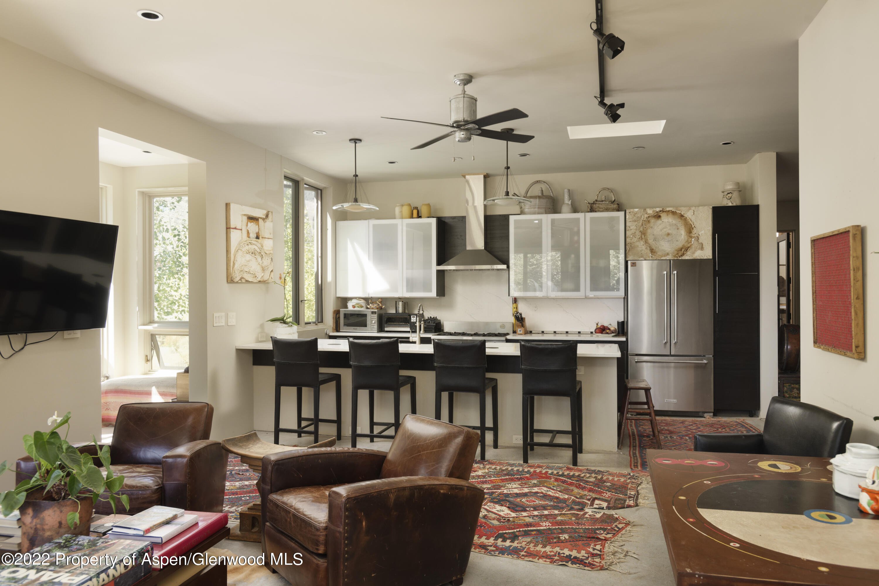 202 Castle View Drive Basalt, CO 81621 - Photo 9 of 29 a living room with furniture kitchen view and a flat screen tv