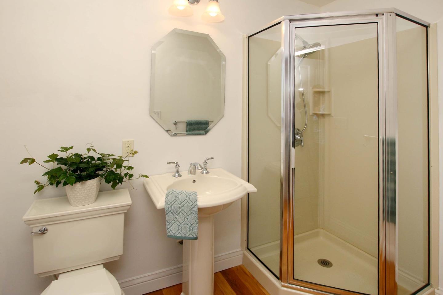 213 Gillette Road Watsonville, CA 95076 - Photo 12 of 27 a bathroom with a sink mirror toilet and shower