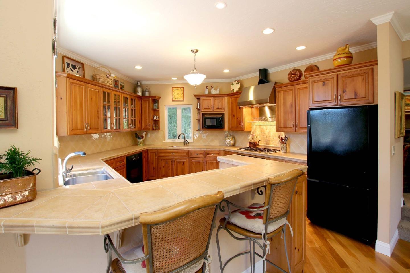 213 Gillette Road Watsonville, CA 95076 - Photo 13 of 27 a kitchen with a refrigerator a sink and a stove